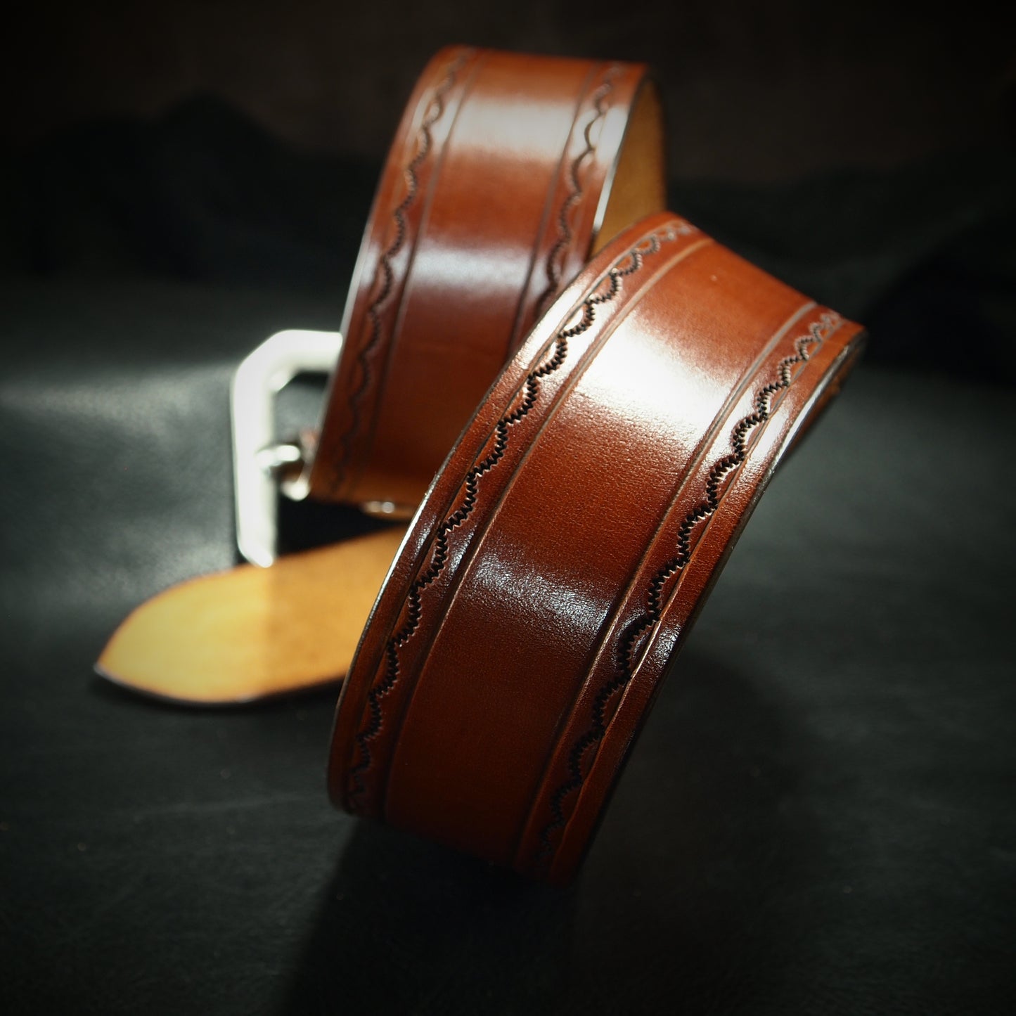 Hand tooled brown belt. Unique FM design