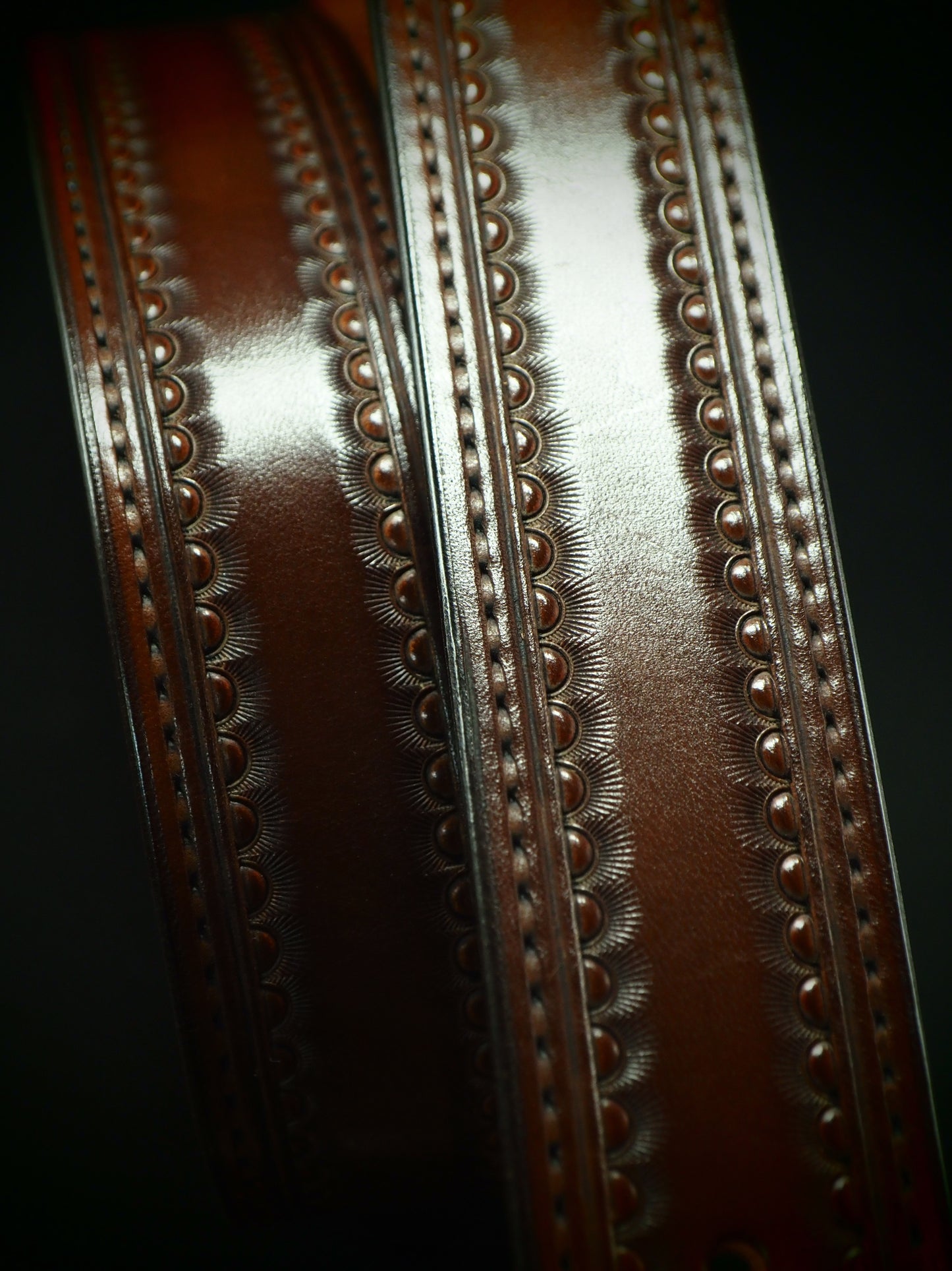 Hand tooled 1.5" rich walnut stamped belt. Unique FM design